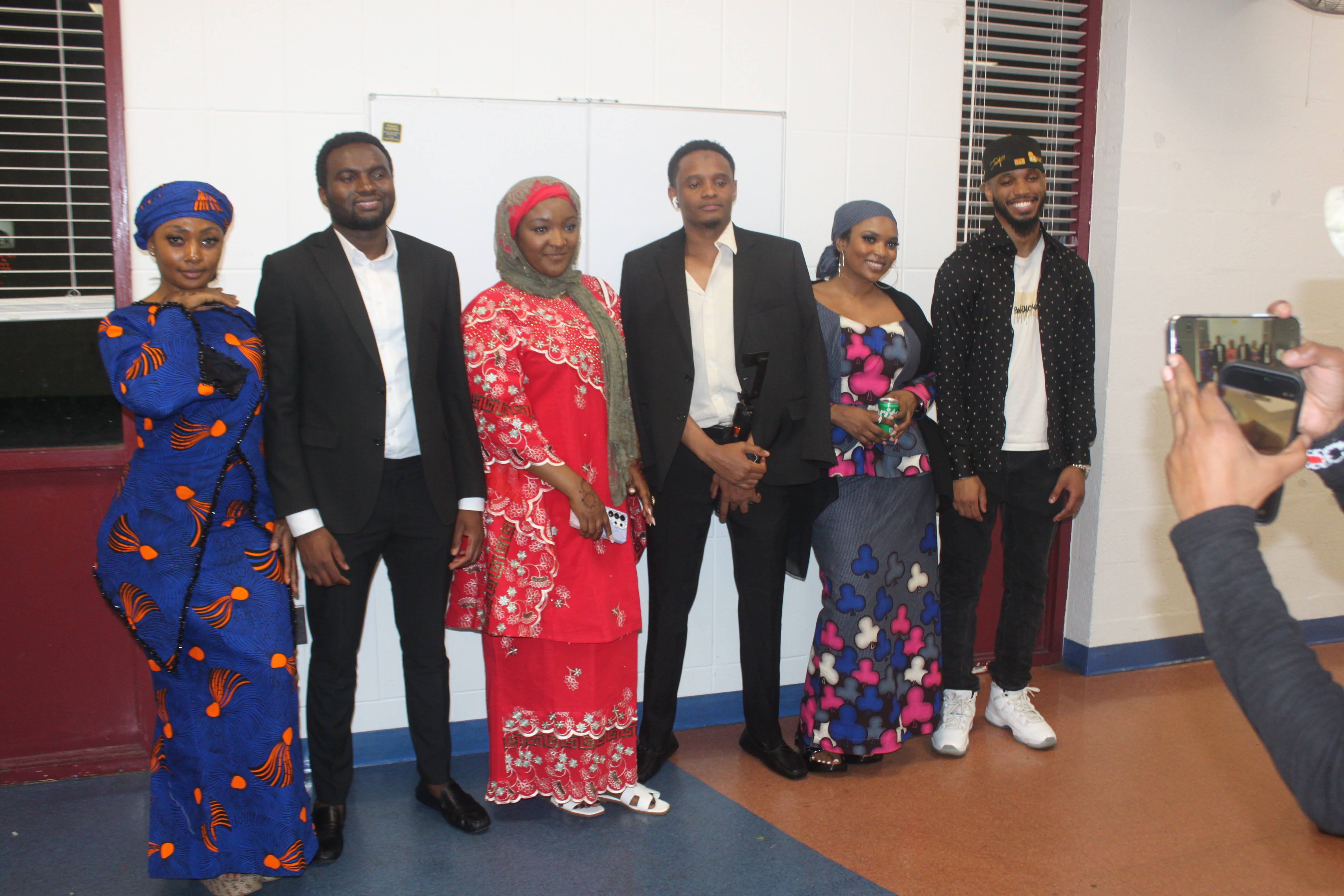 Group of Fulani community members in traditional and formal dress posing together at the Al Ada dinner